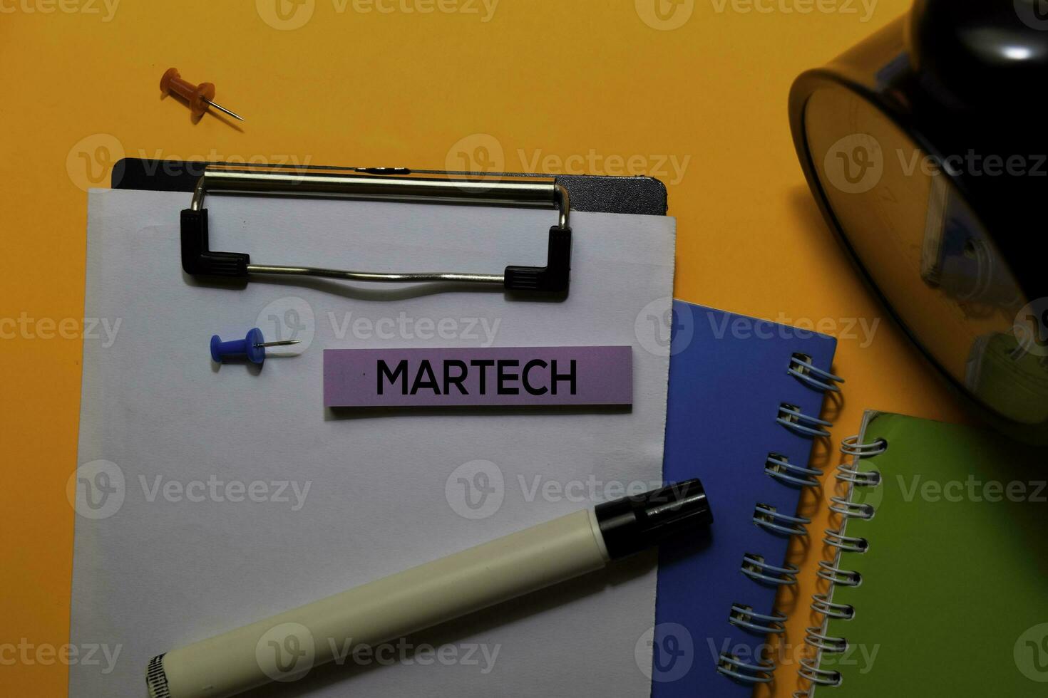 Martech write on sticky notes. Isolated on orange table background photo