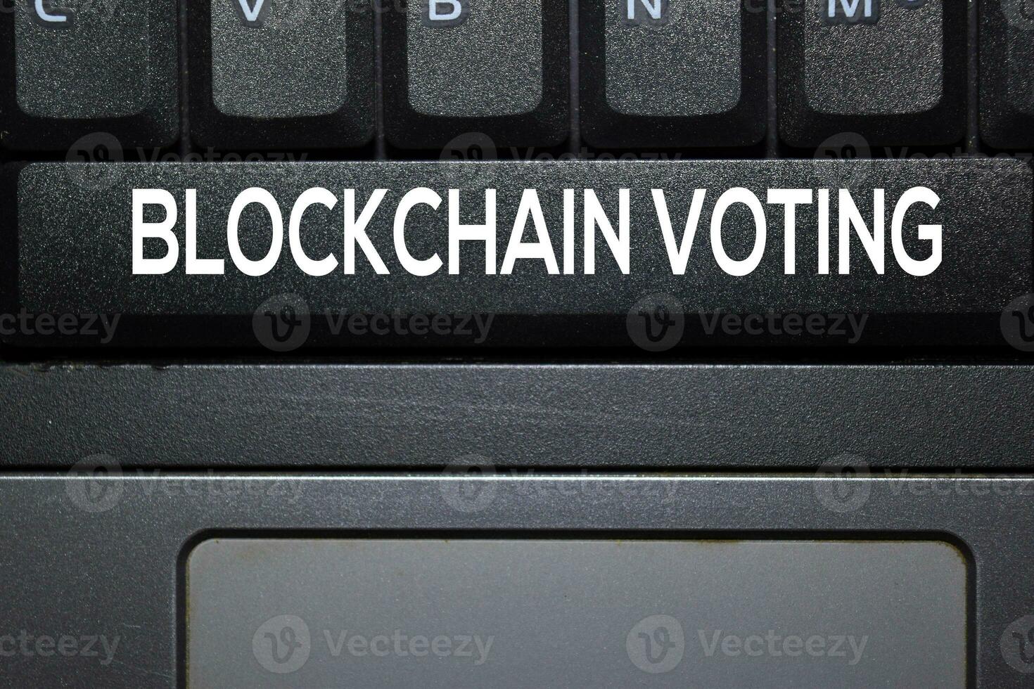Blockchain Voting write on keyboard isolated on laptop background photo
