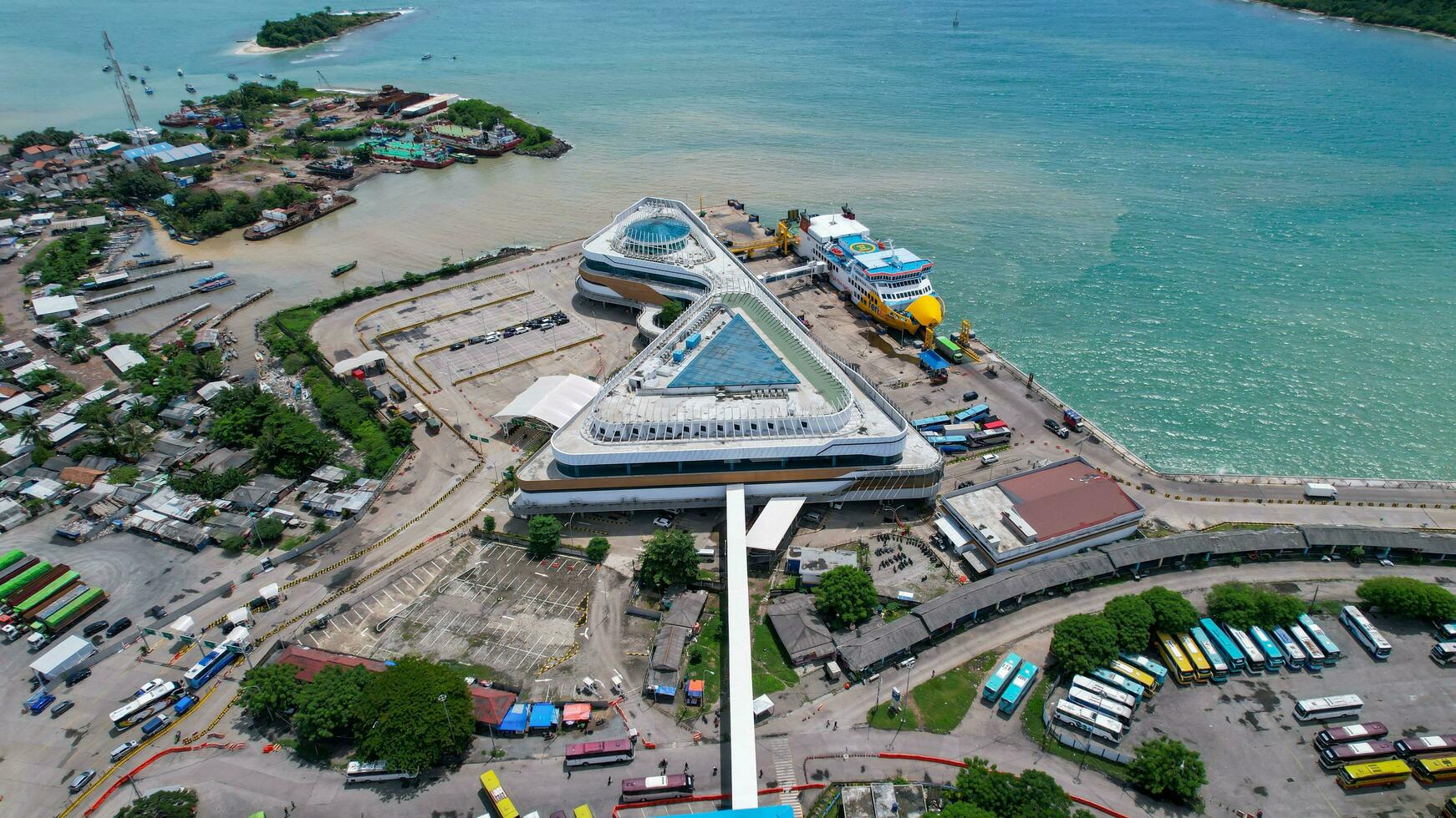 Aerial view of vehicles and passengers queueing to enter the ferry ship at the Merak Seaport. Banten, Indonesia, February 26, 2022 photo