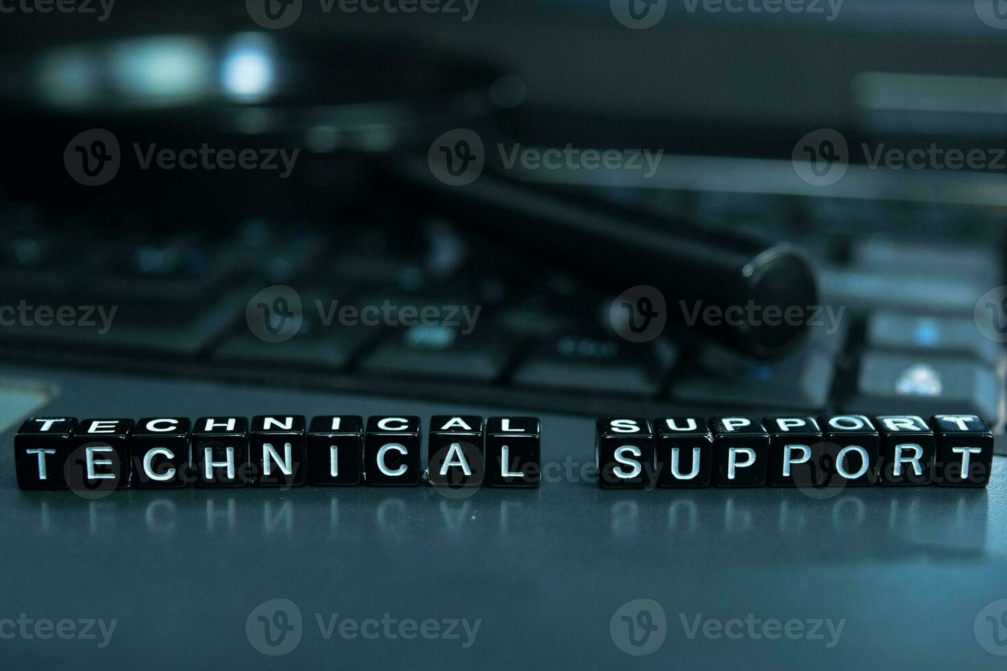 Technical Support text wooden blocks in laptop background. Business and technology concept photo