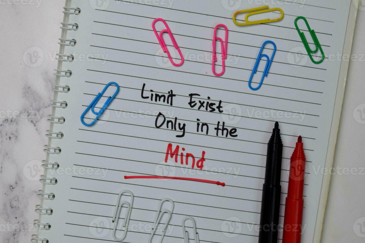Limit Exist Only In The Mind write on a book isolated wooden table. photo