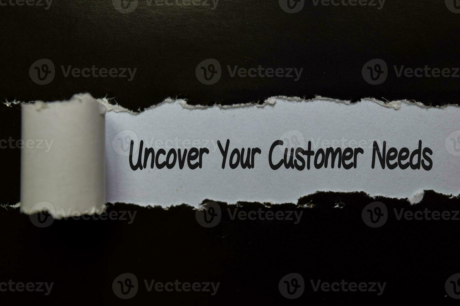 Uncover Your Customer Needs write on white and black torn paper photo