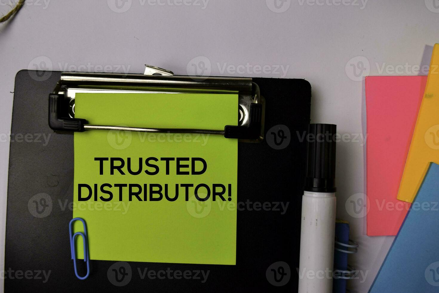 Trusted Distributor on sticky notes isolated on white background. photo