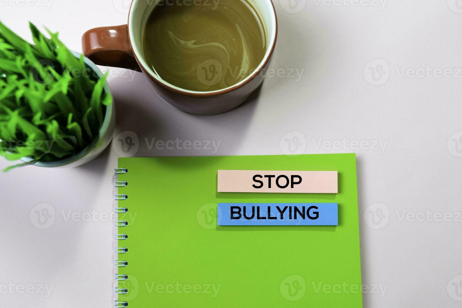 Stop Bullying text on sticky notes with office desk concept photo