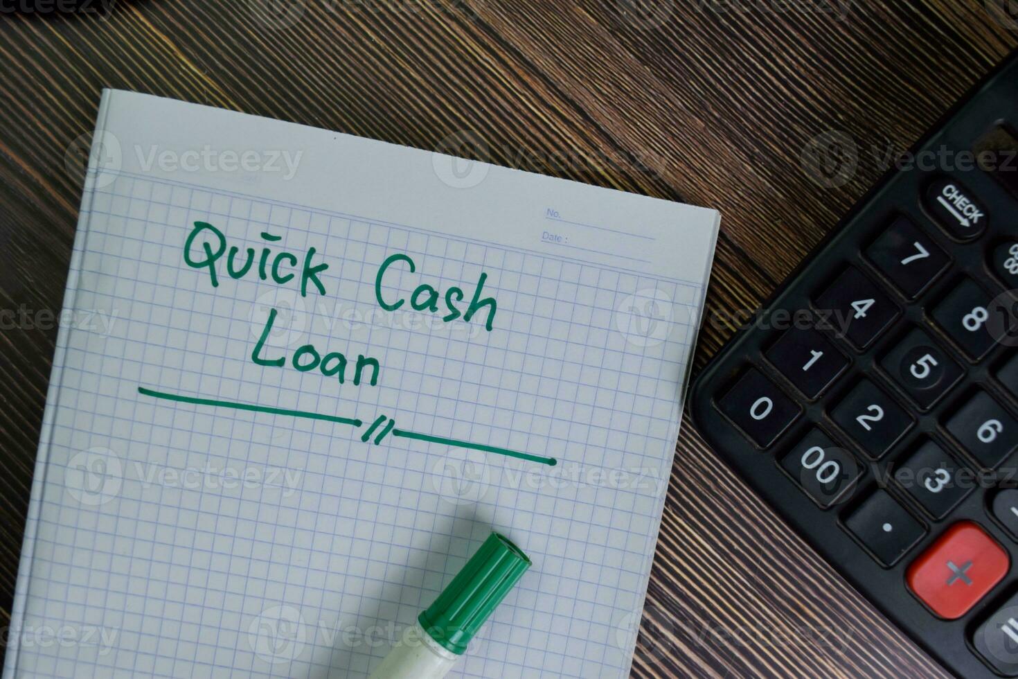 Quick Cash Loan write on a book with keywords isolated on Wooden Table. photo