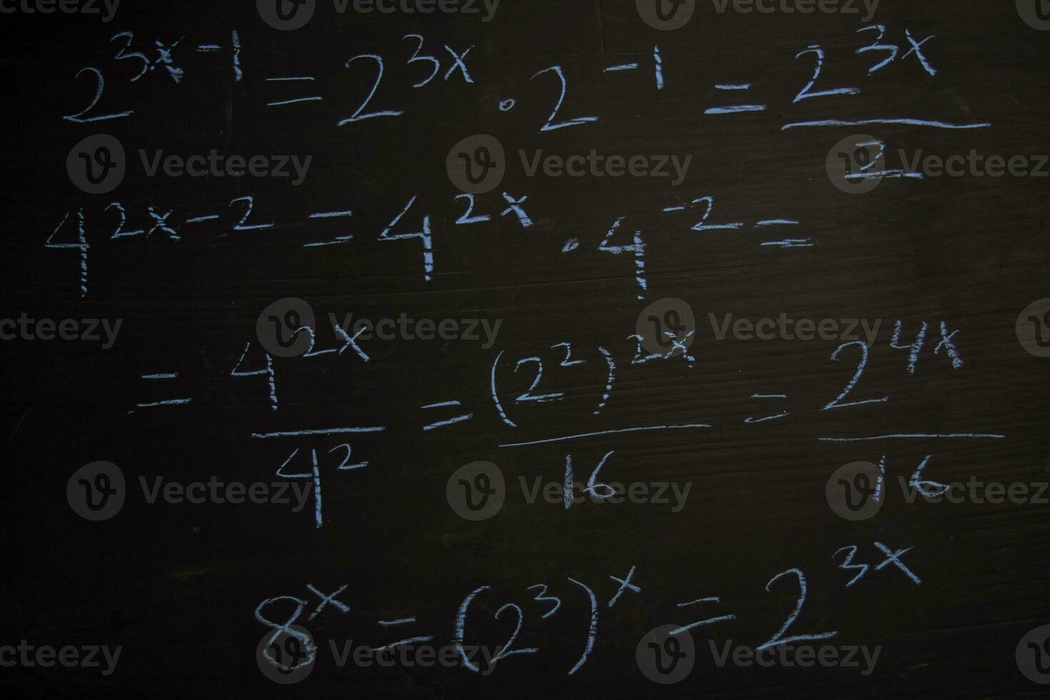 Close up math formulas written on a blackboard. Education concept photo