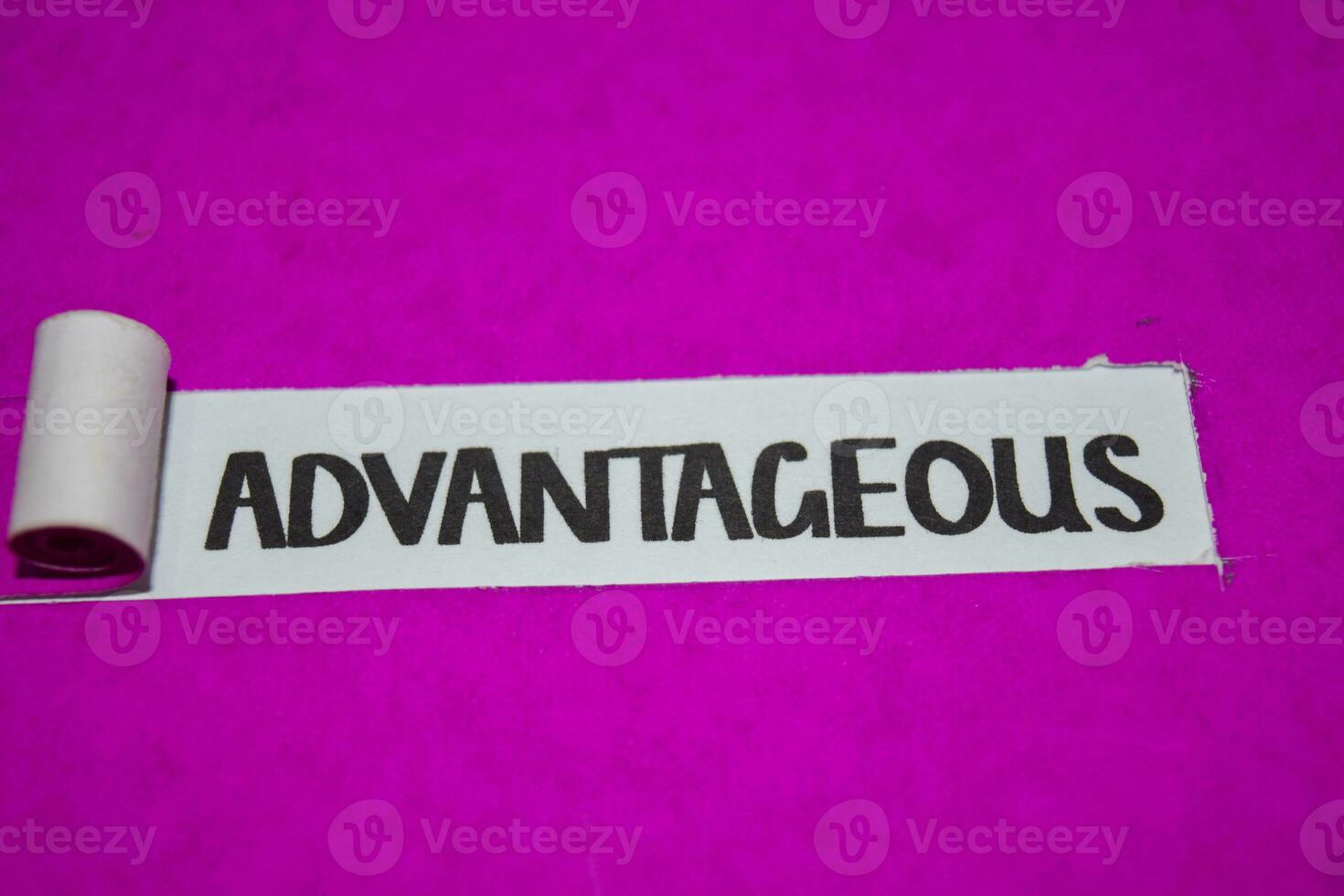 Advantageous text, Inspiration and positive vibes concept on purple torn paper photo