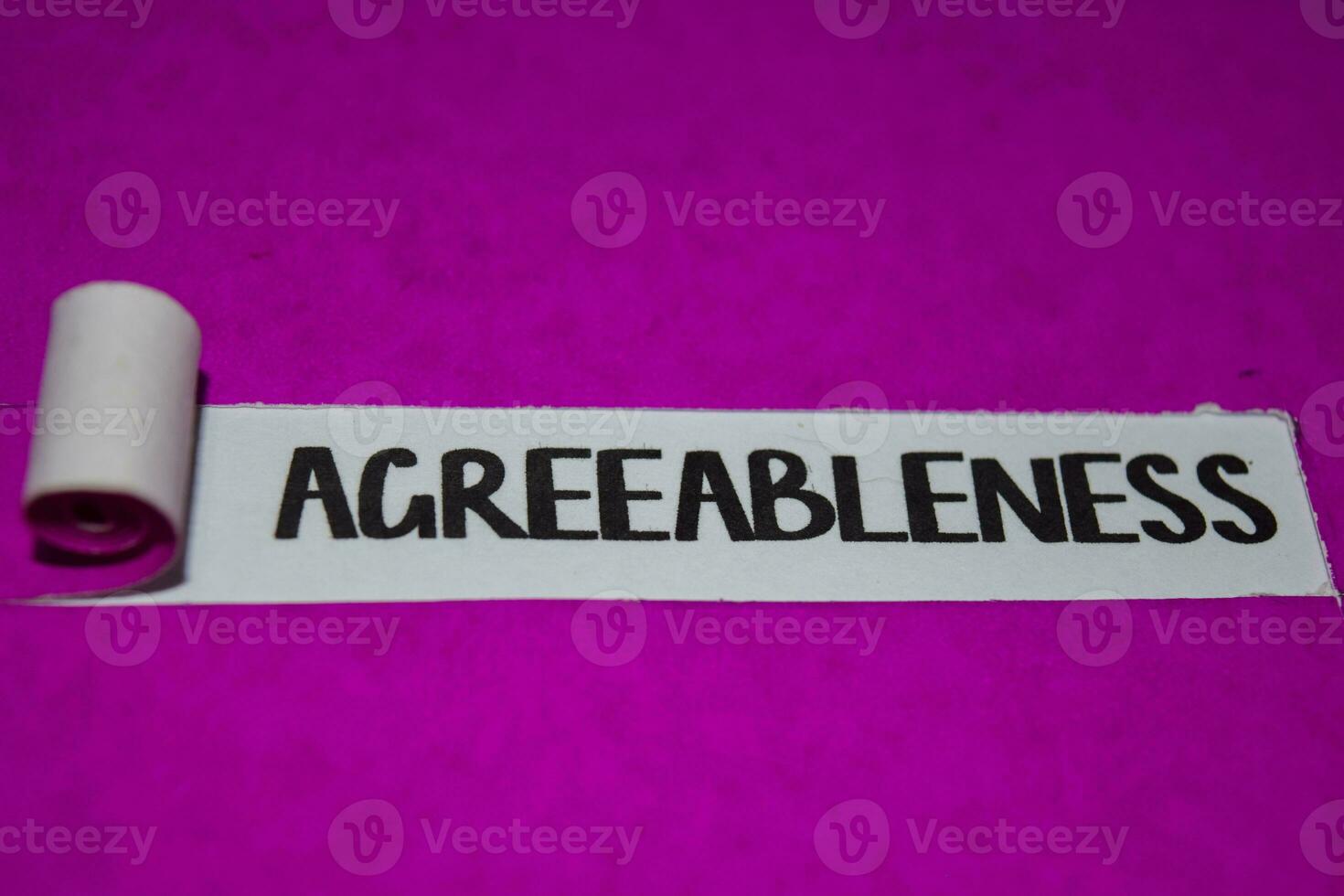 Agreeableness text, Inspiration and positive vibes concept on purple torn paper photo