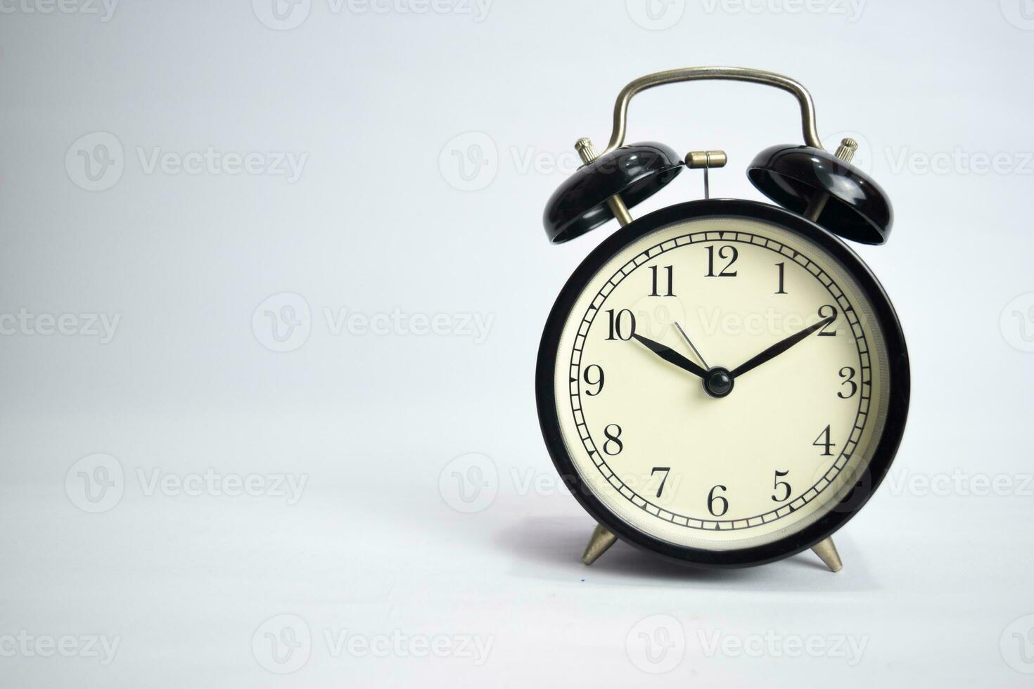 Clock ticking to 10 o'clock isolated on white background photo