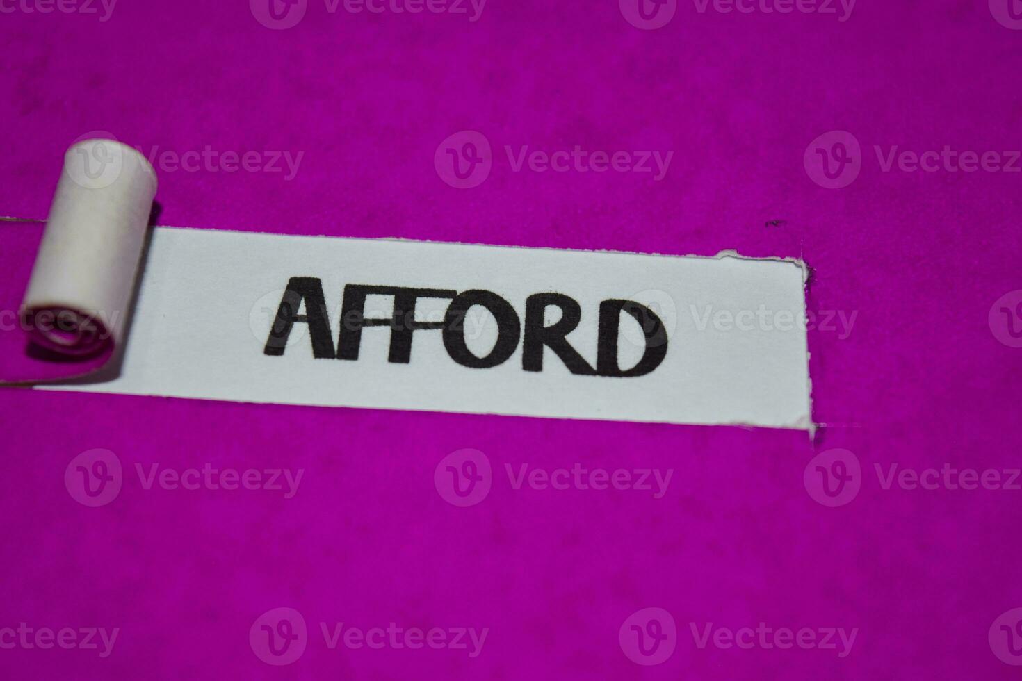 Afford text, Inspiration and positive vibes concept on purple torn paper photo
