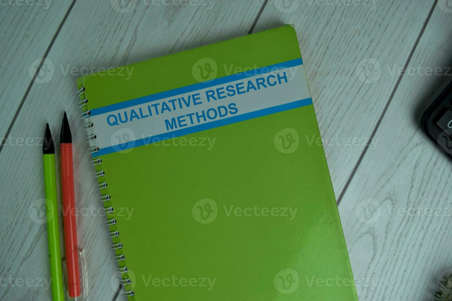 Qualitative Research Methods write on a book isolated on office desk. photo
