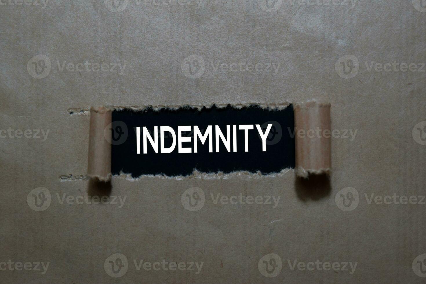 Close up Indemnity write inside on torn paper photo