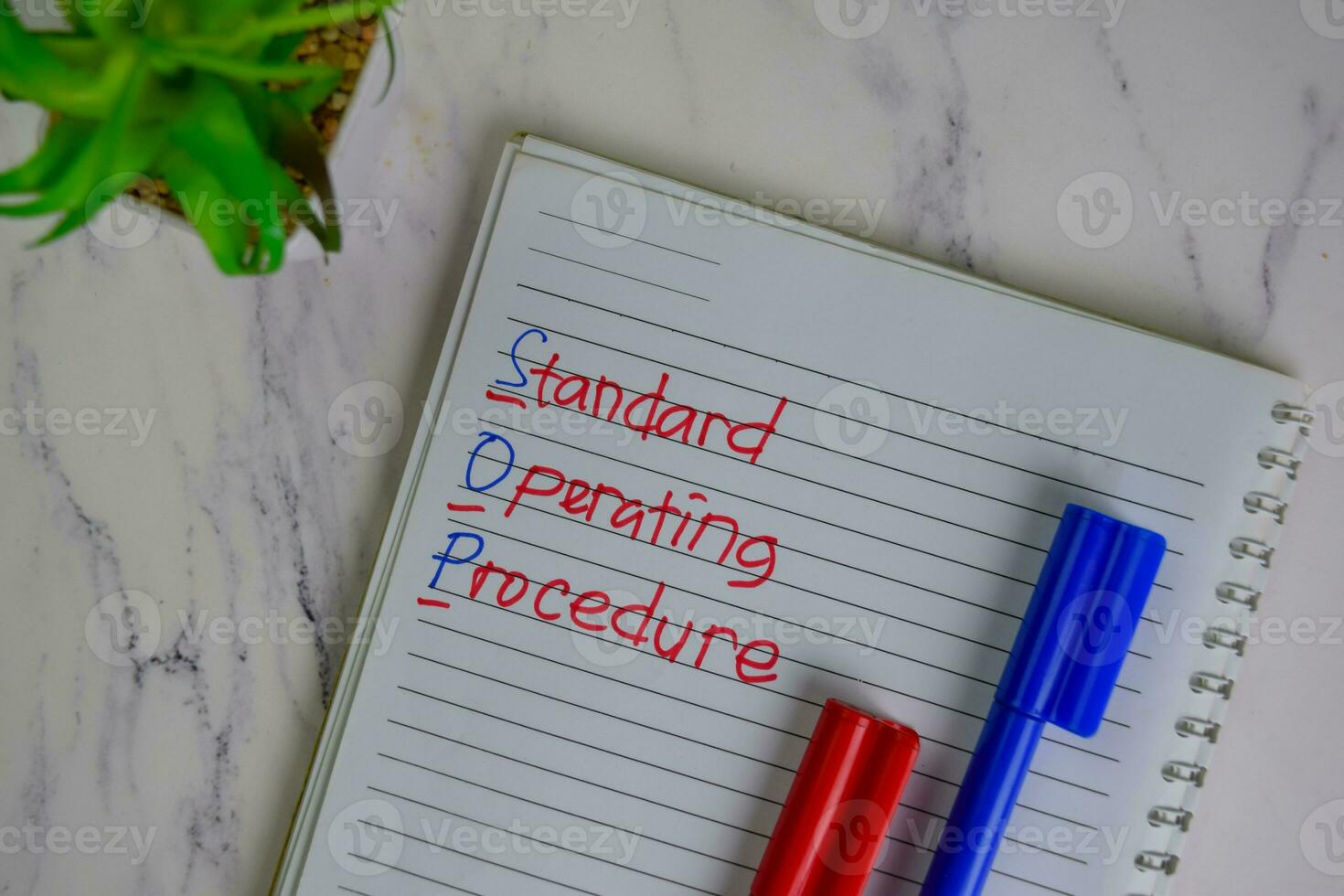 SOP - Standard Operating Procedure write on a book isolated on Wooden Table. photo