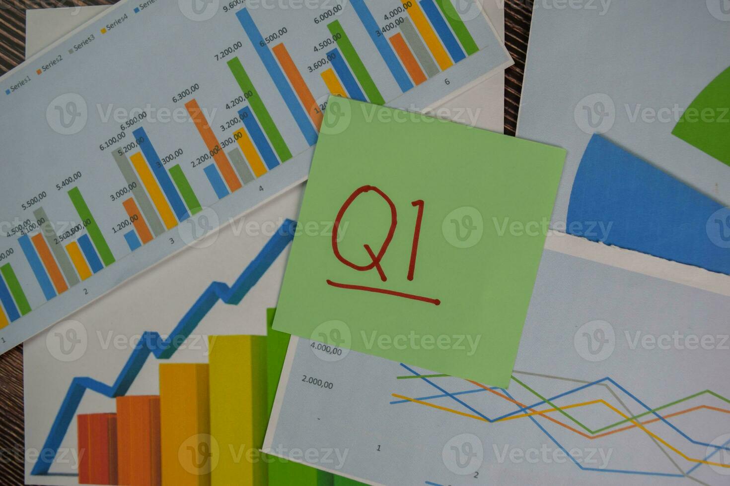 Q1 - 1st Quarter Period write on sticky notes isolated on Wooden Table. Stock market concept photo