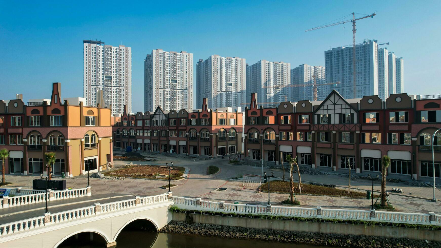 Aerial view of Amsterdam Dutch dancing houses above the southeast of the jakarta river in the spring landscape of the old European city at Pantai Indah Kapuk. Jakarta, Indonesia, June 23, 2022 photo