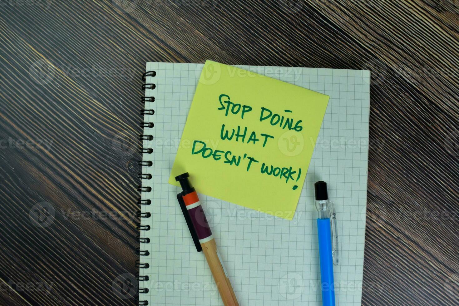 Concept of Stop Doing What Doesn't Work write on sticky notes isolated on Wooden Table. photo