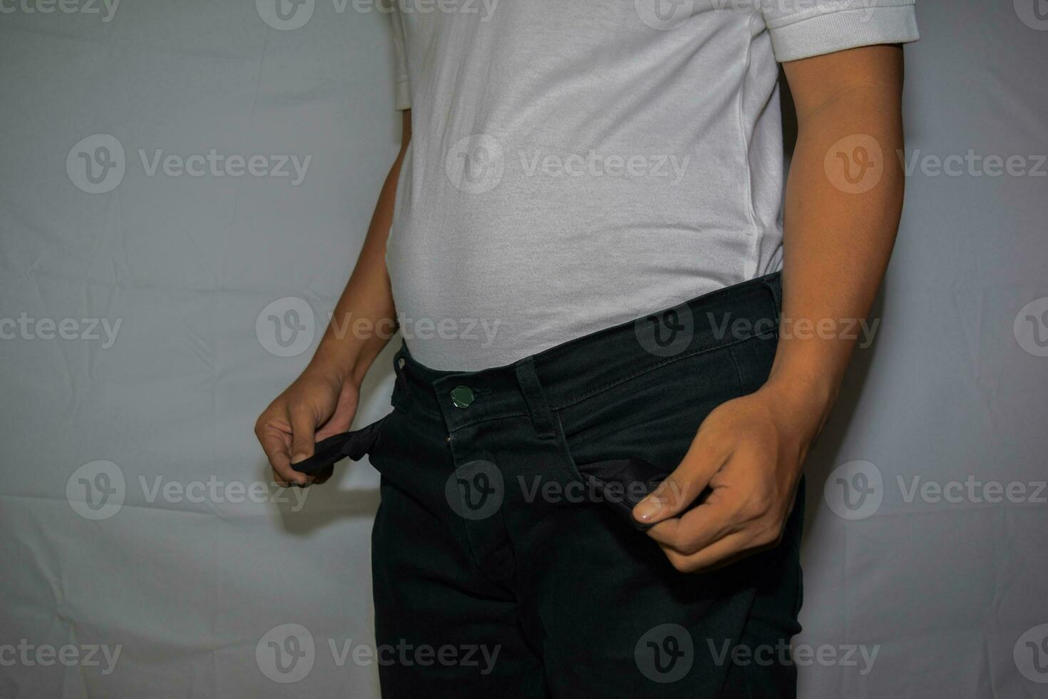 Close up Asian man shows his empty pockets isolated on white background photo