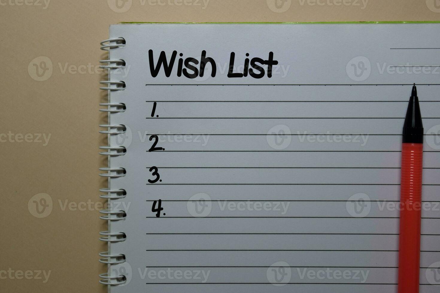 Wish List write on a book isolated on office desk. photo