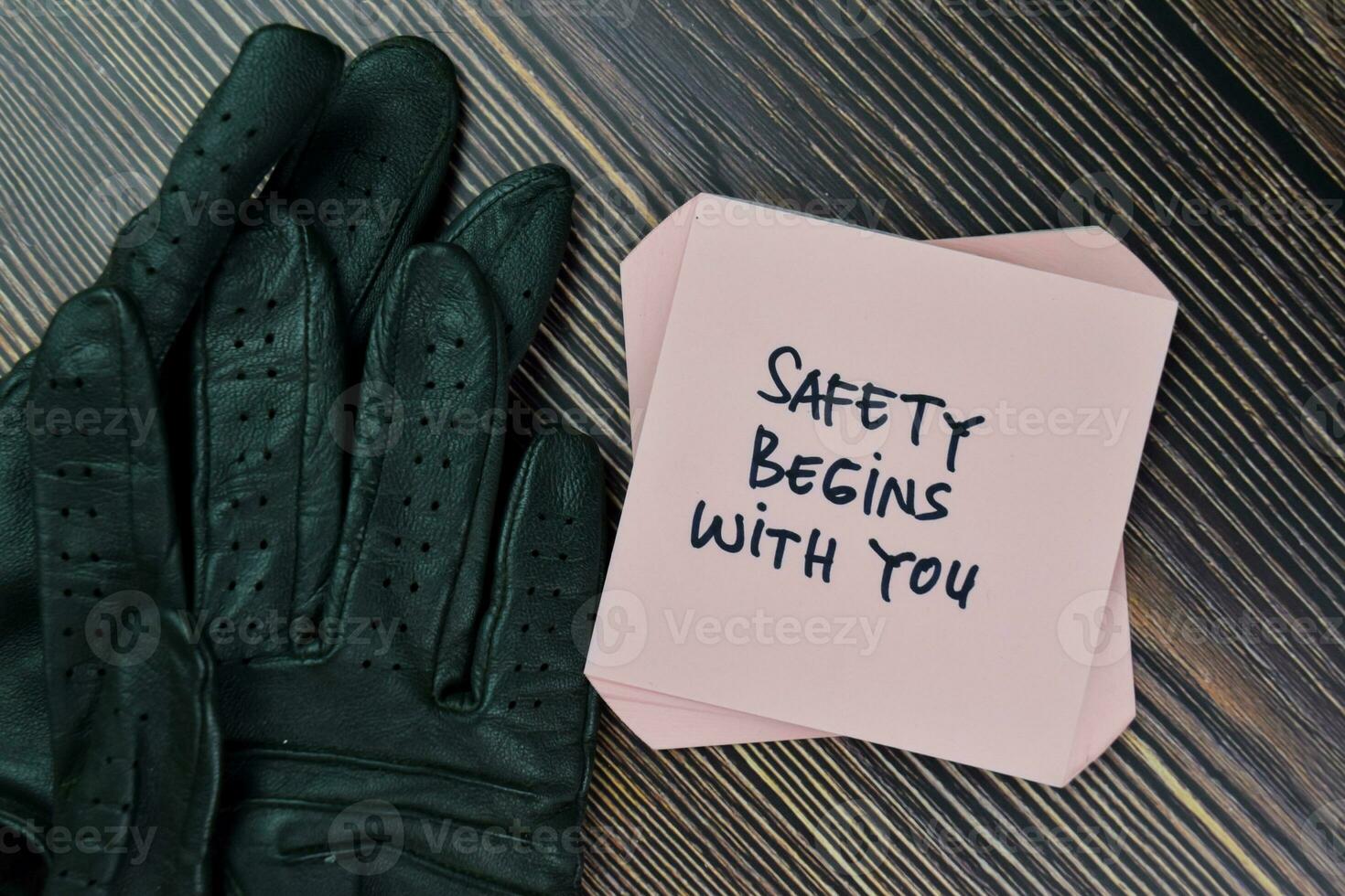 Safety Begins With You write on sticky notes isolated on Wooden Table. photo