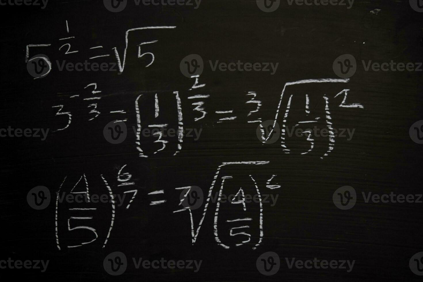 Close up math formulas written on a blackboard. Education concept photo