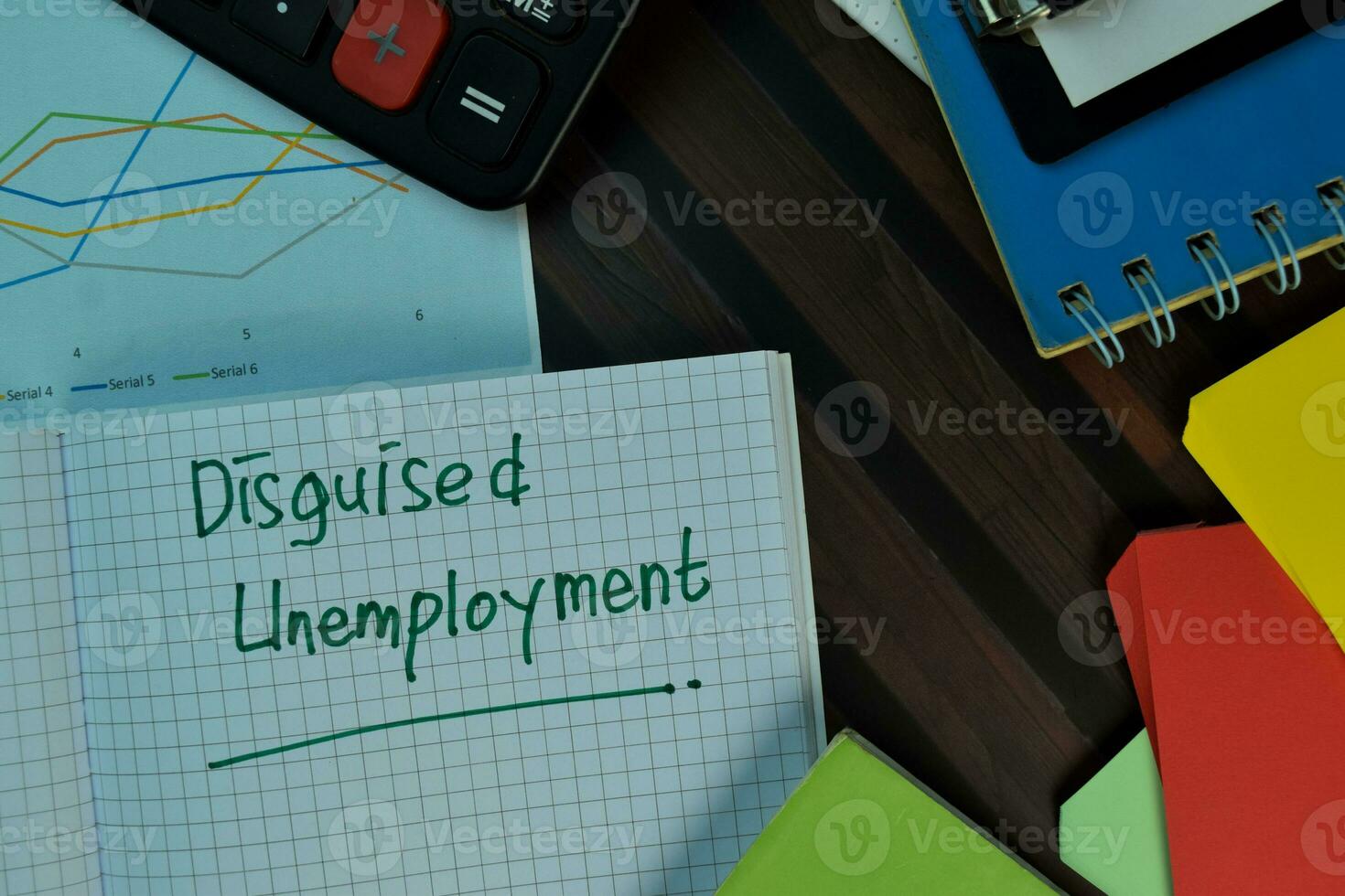 Disguised Unemployement write on a book isolated on Wooden Table. Business or Finance concept photo