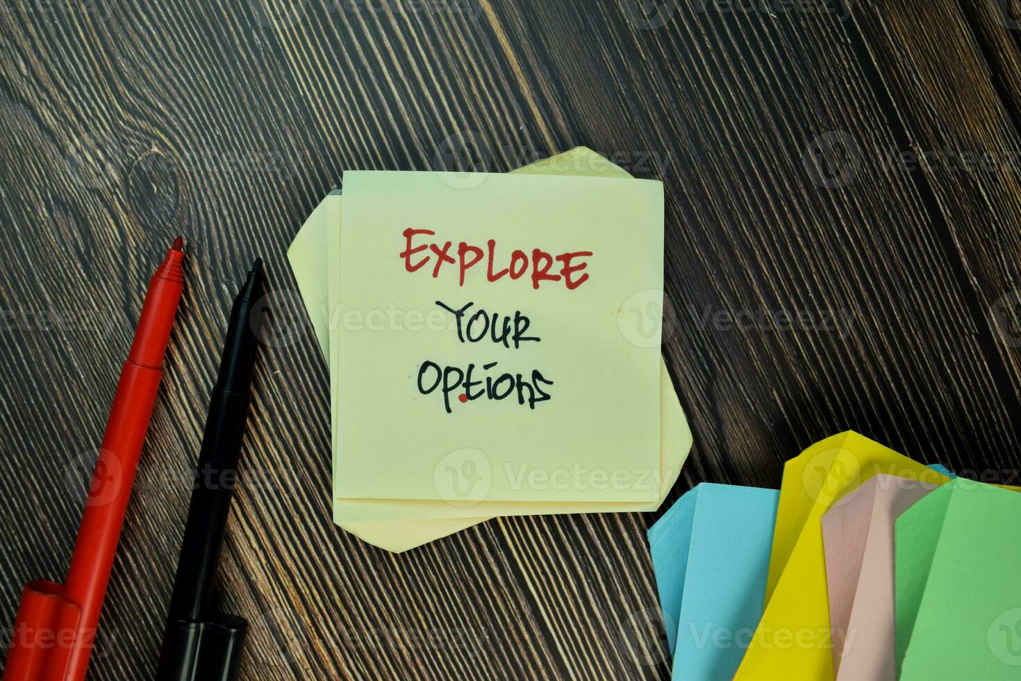Explore Your Options write on sticky note isolated on Wooden Table. photo