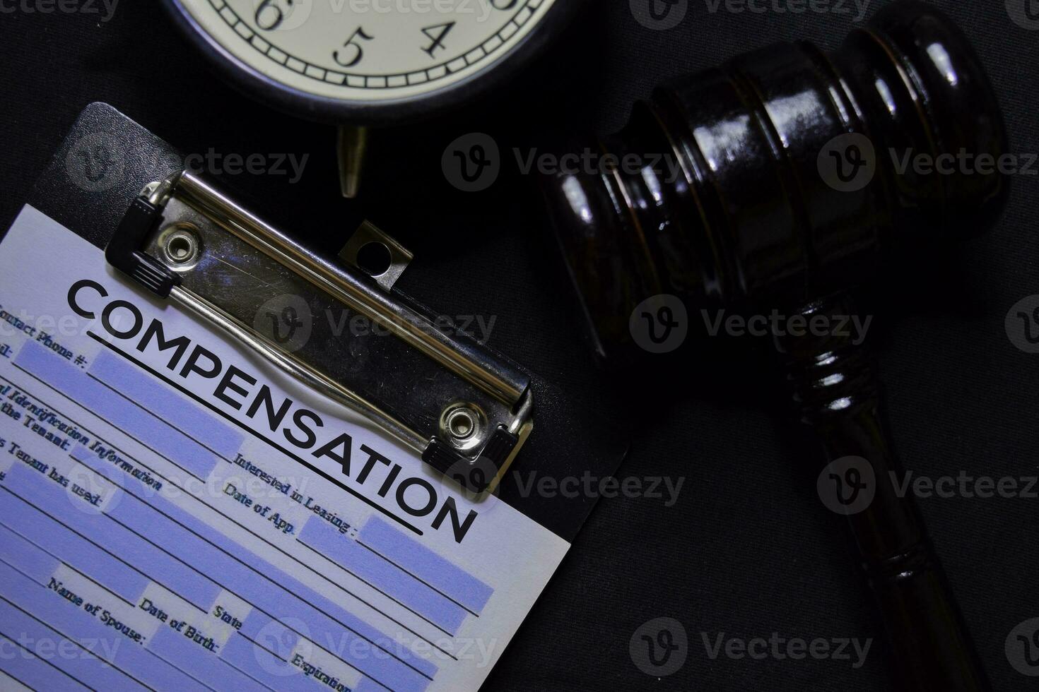 Compensation text on Document and gavel isolated on office desk. Law concept photo