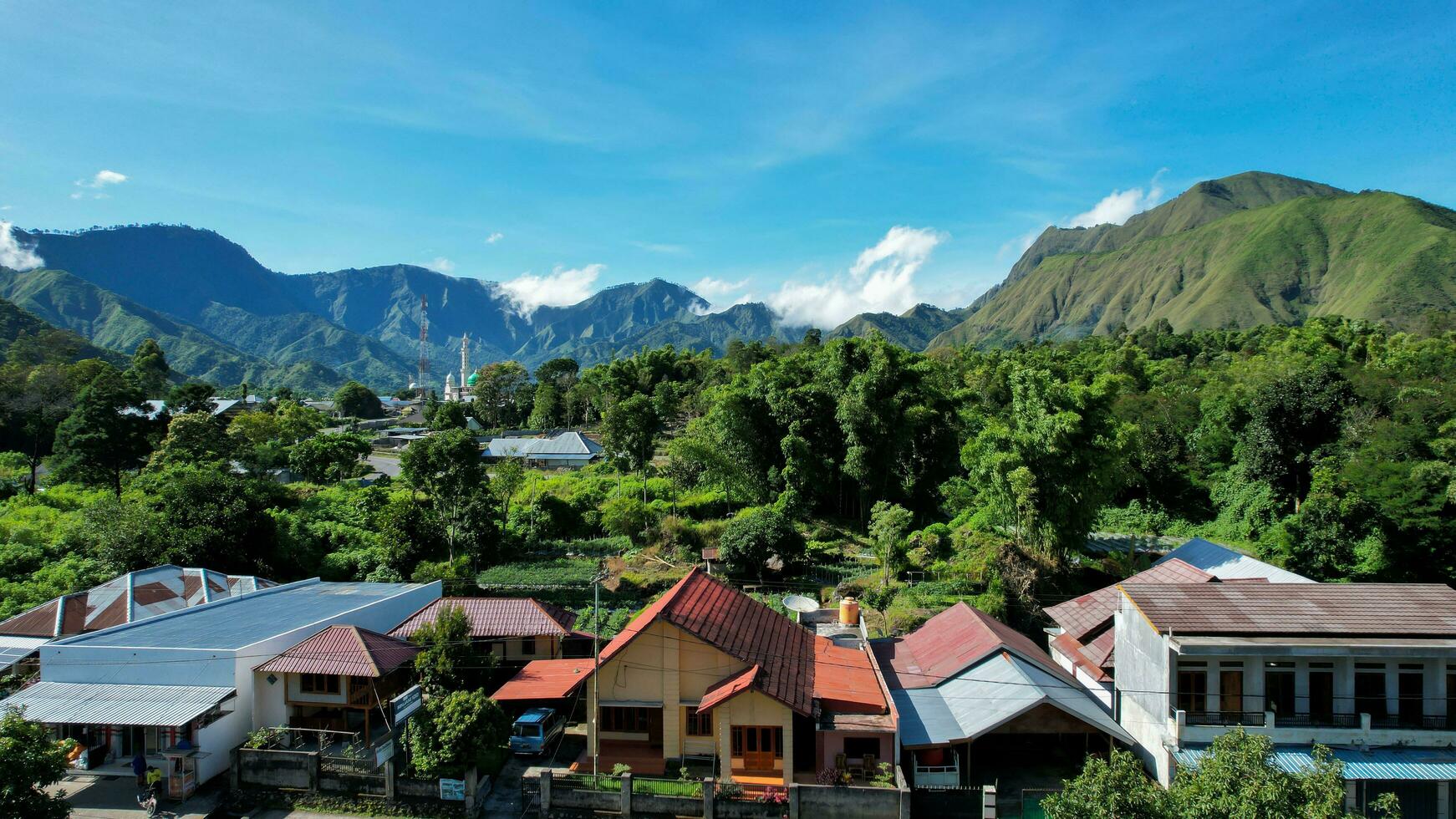 Aerial view of some agricultural fields in Sembalun. Sembalun is situated on the slope of mount Rinjani and is surrounded by beautiful green mountains. Lombok, Indonesia, March 22, 2022 photo