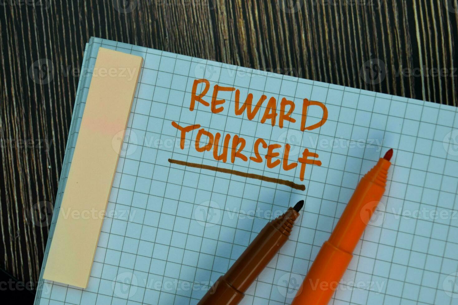 Reward Yourself write on a book isolated on Wooden Table. Motivation or Insipiration Concept photo