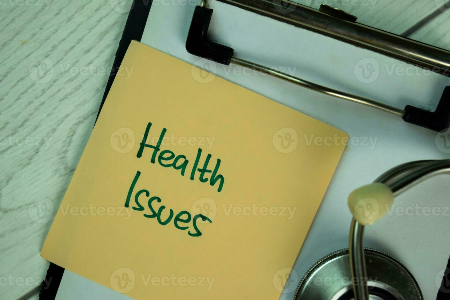 Health Issues write on sticky notes isolated on Wooden Table. photo