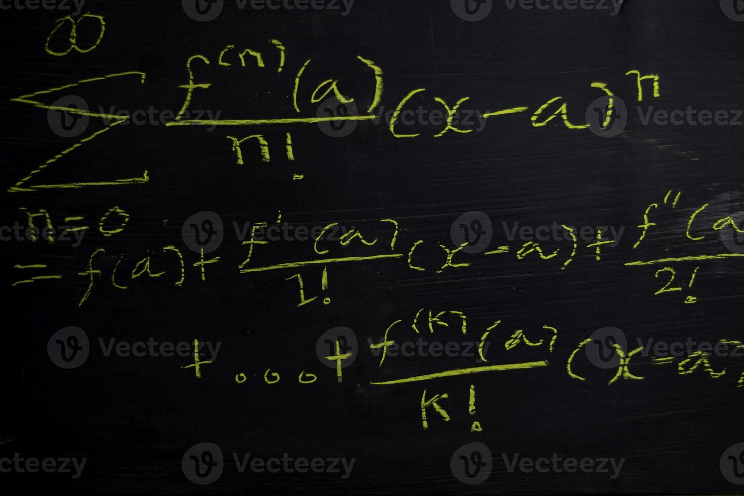 Close up math formulas written on a blackboard. Education concept photo