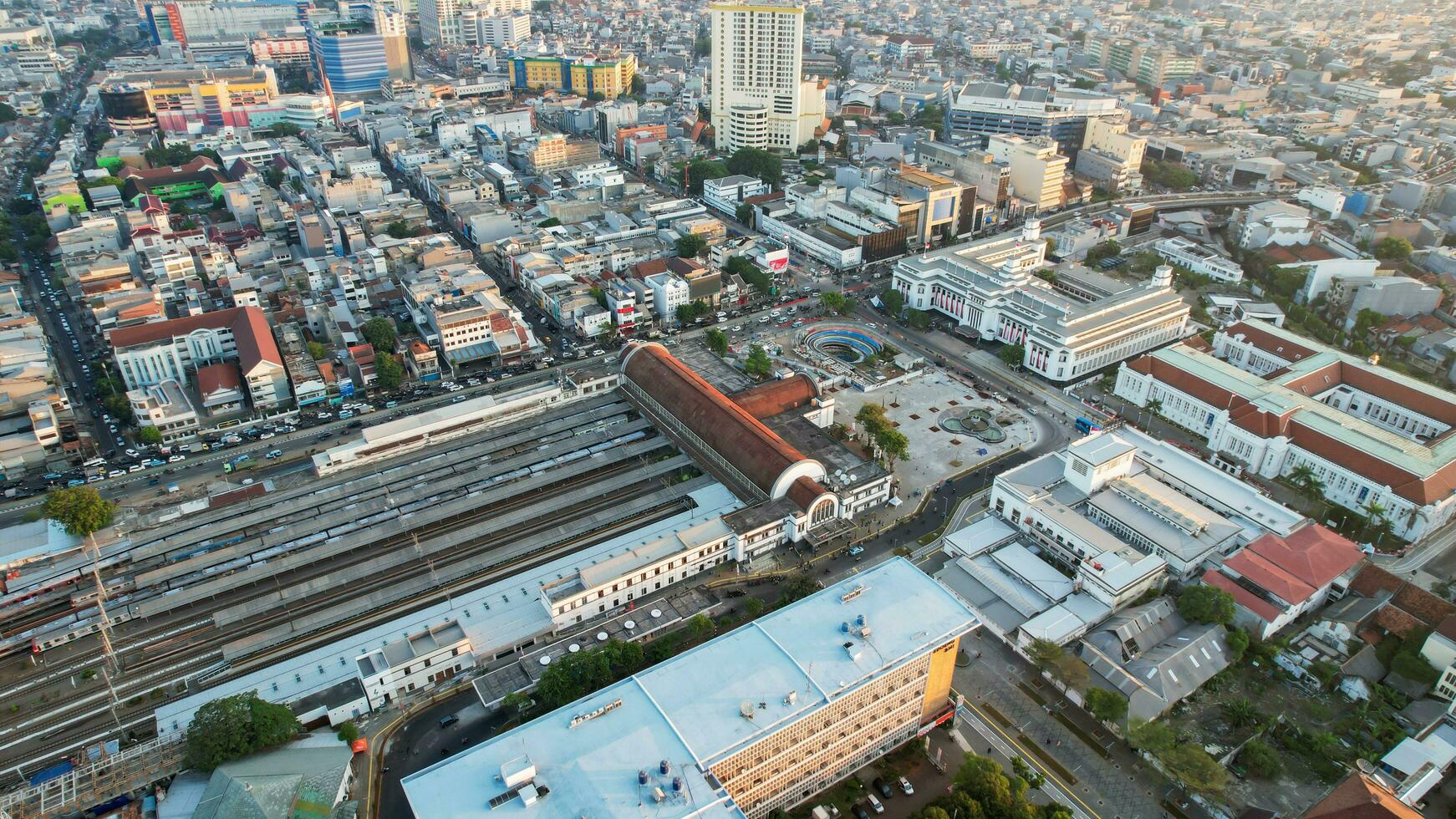 Aerial view of Jakarta Kota Train Station with Jakarta cityscape background. Jakarta, Indonesia, August 30, 2022 photo