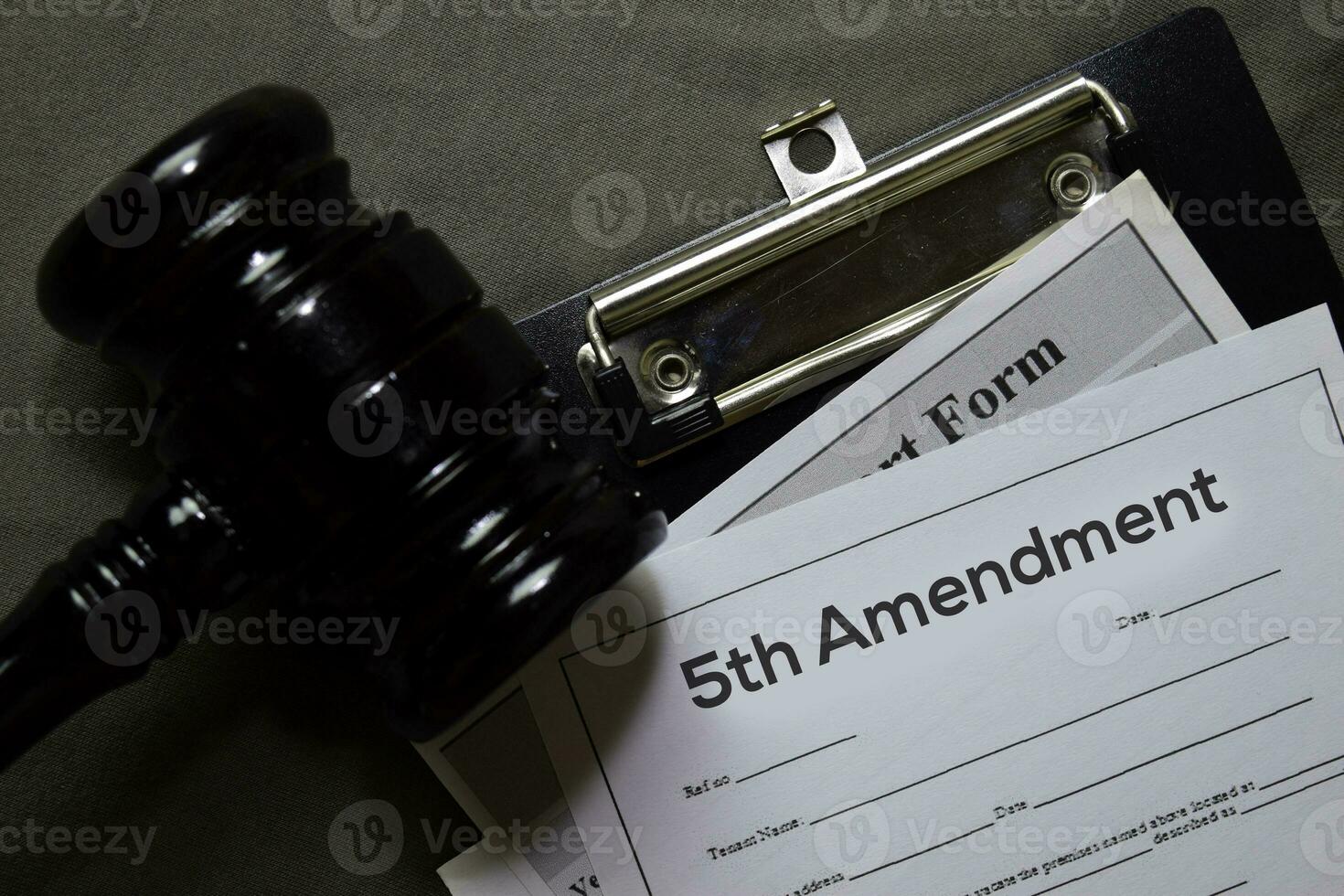 5th Amandment text on Document and gavel isolated on office desk. Law concept photo