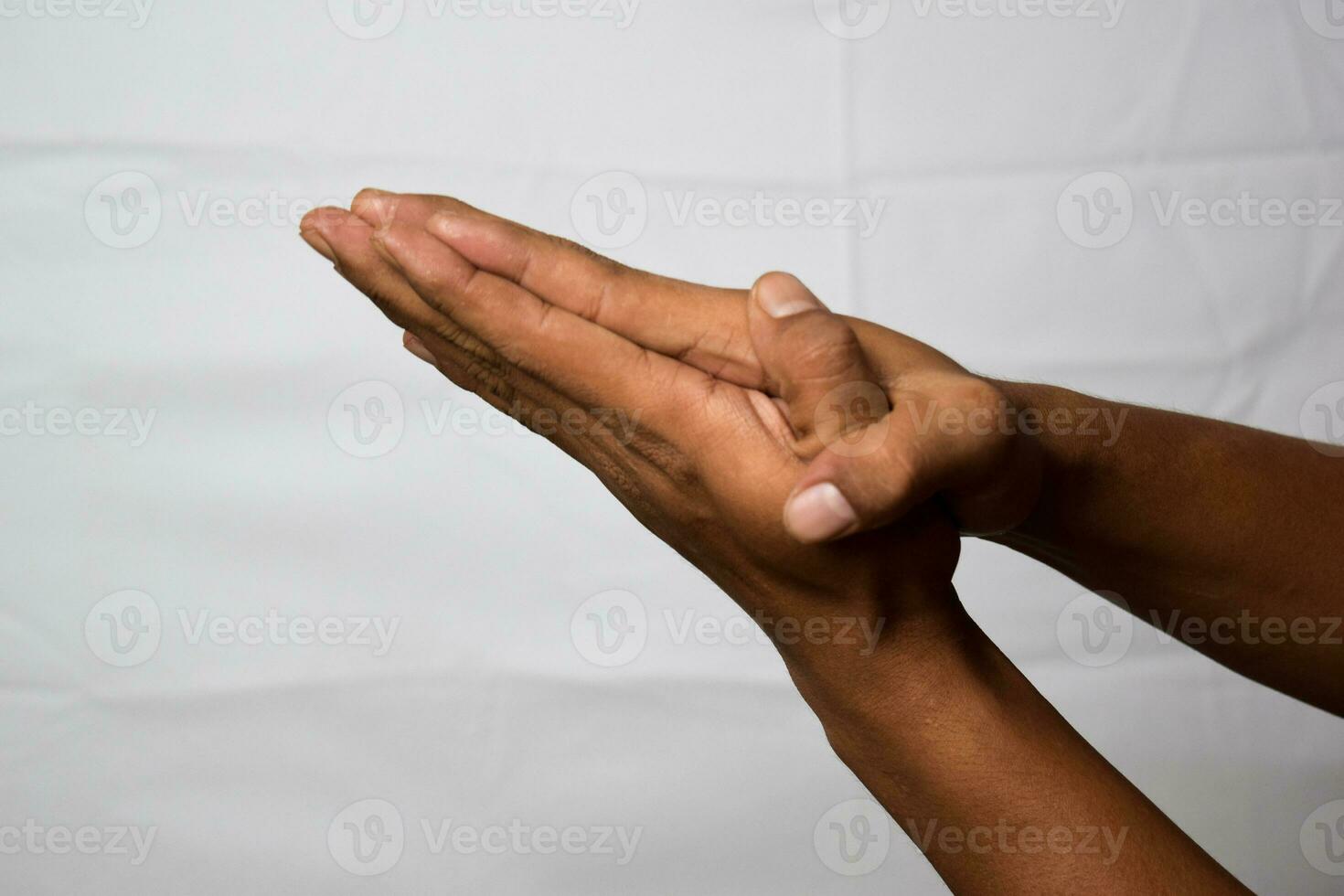 Close up Asian man shows hand gestures it means Please isolated on white background photo