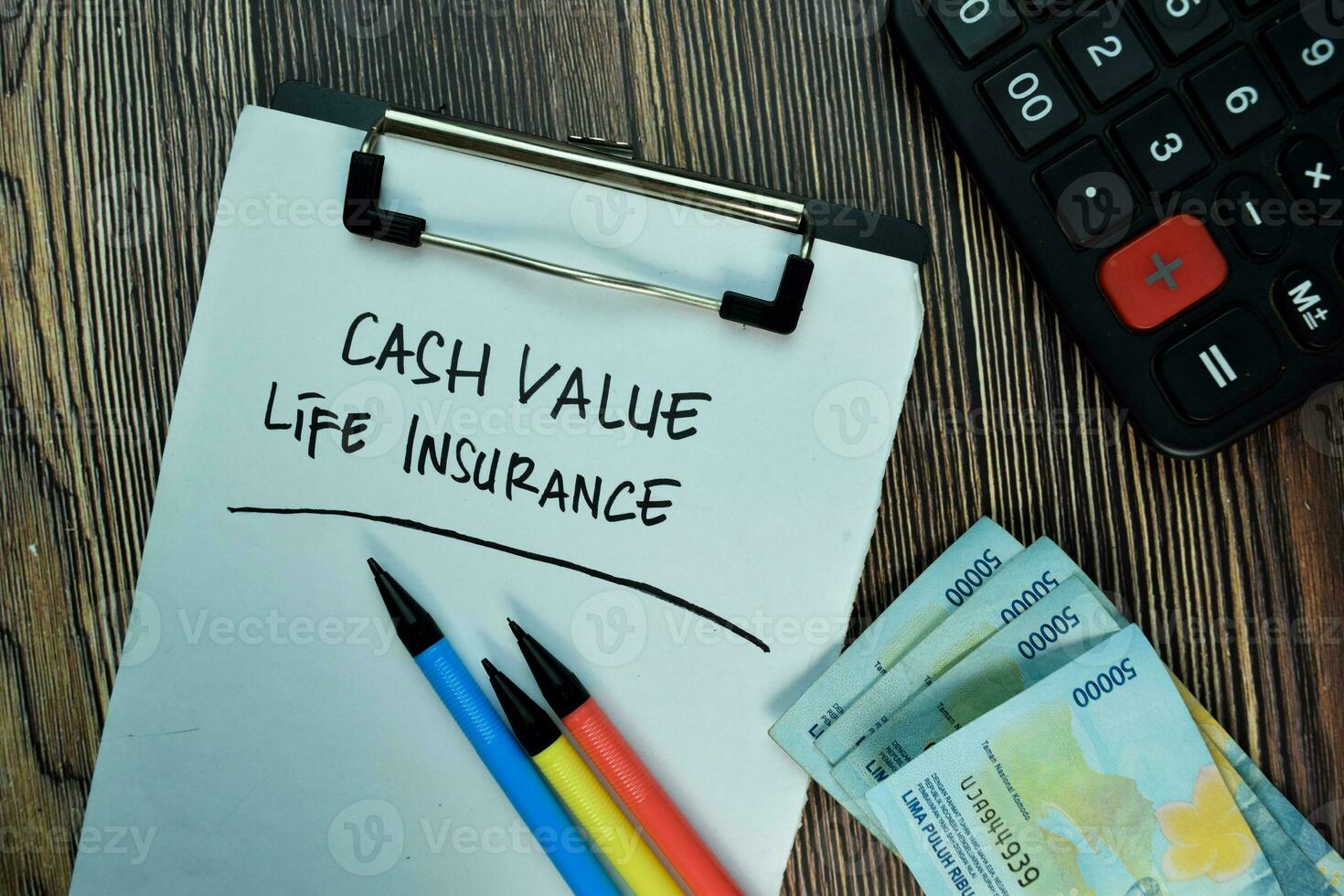 Cash Value Life Insurance write on a paperwork isolated on Wooden Table. Business or Financial Concept photo