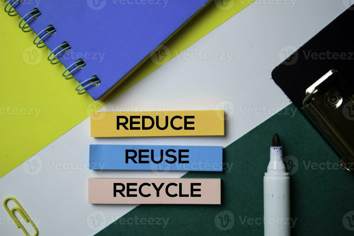 Reduce. Reuse. Recycle text on sticky notes with office desk concept photo