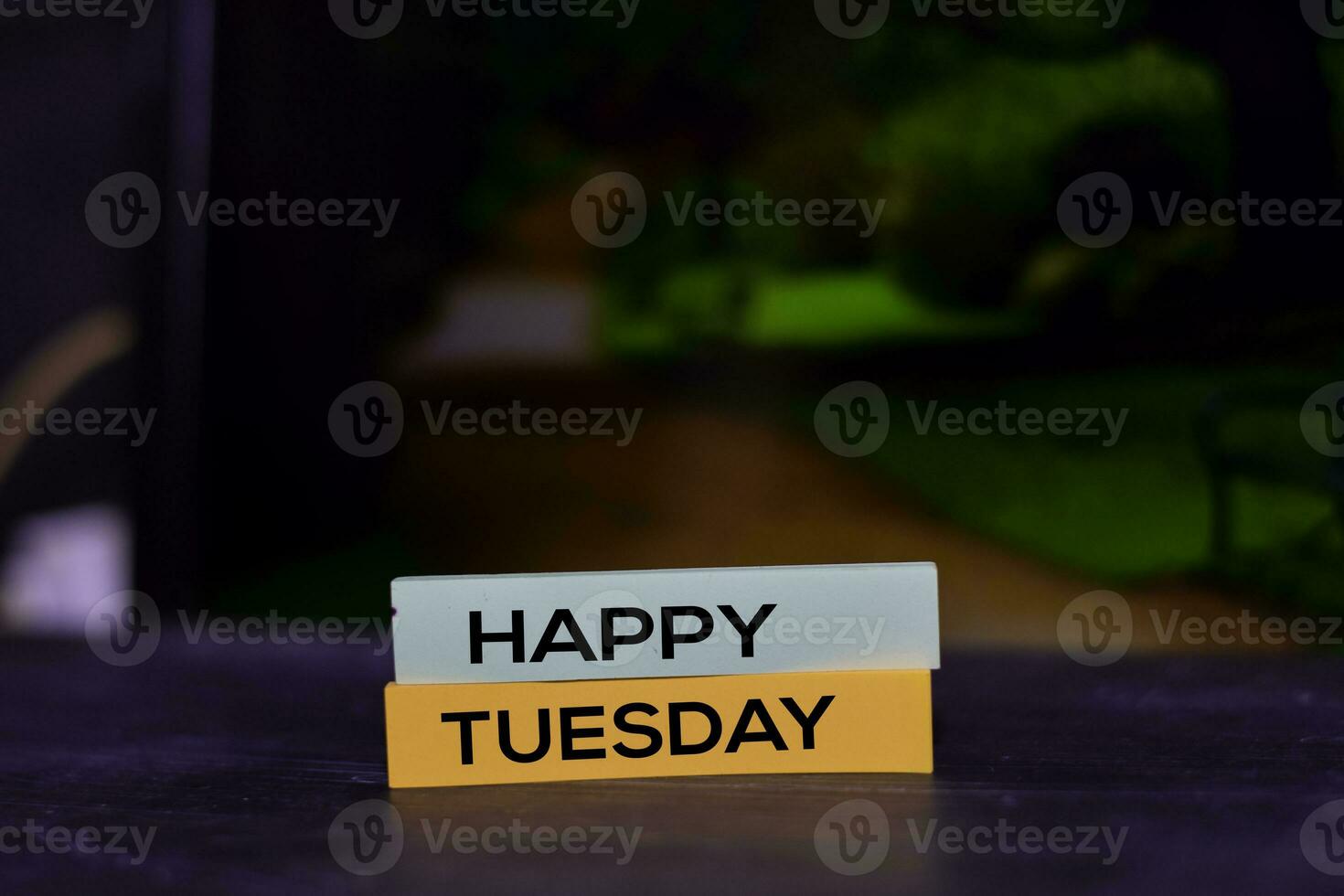Happy Tuesday on the sticky notes with bokeh background photo