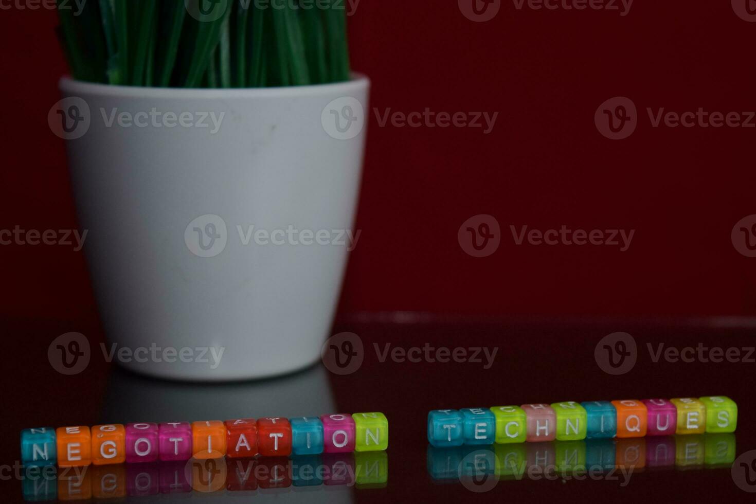 Negotiation techniques text at colorful wooden block on red background. Desk office and education concept photo