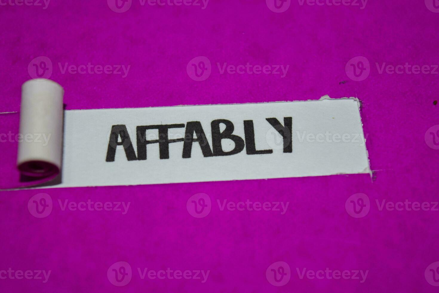 Affably text, Inspiration and positive vibes concept on purple torn paper photo