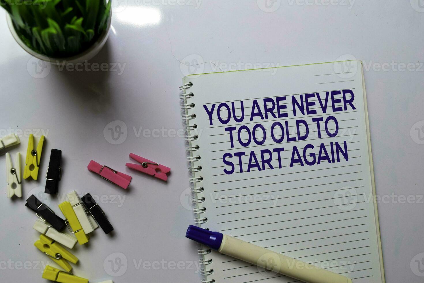 You Are Never Too Old To Start Again text on a book at office desk. Motivation concept photo