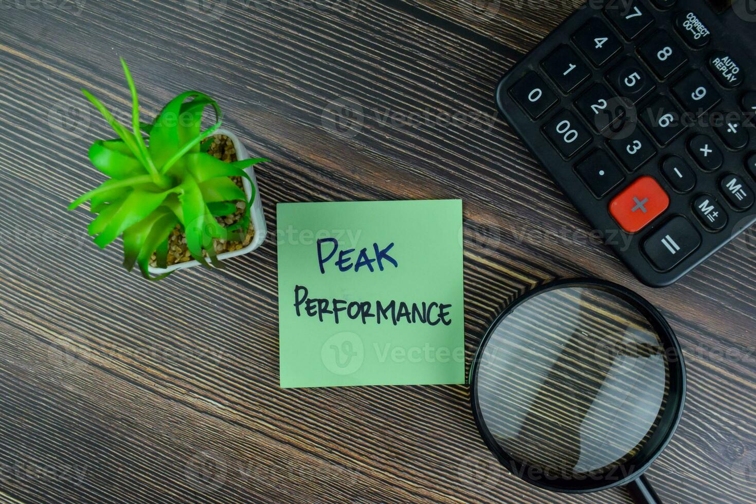 Peak Performance write on sticky notes isolated on Wooden Table. photo