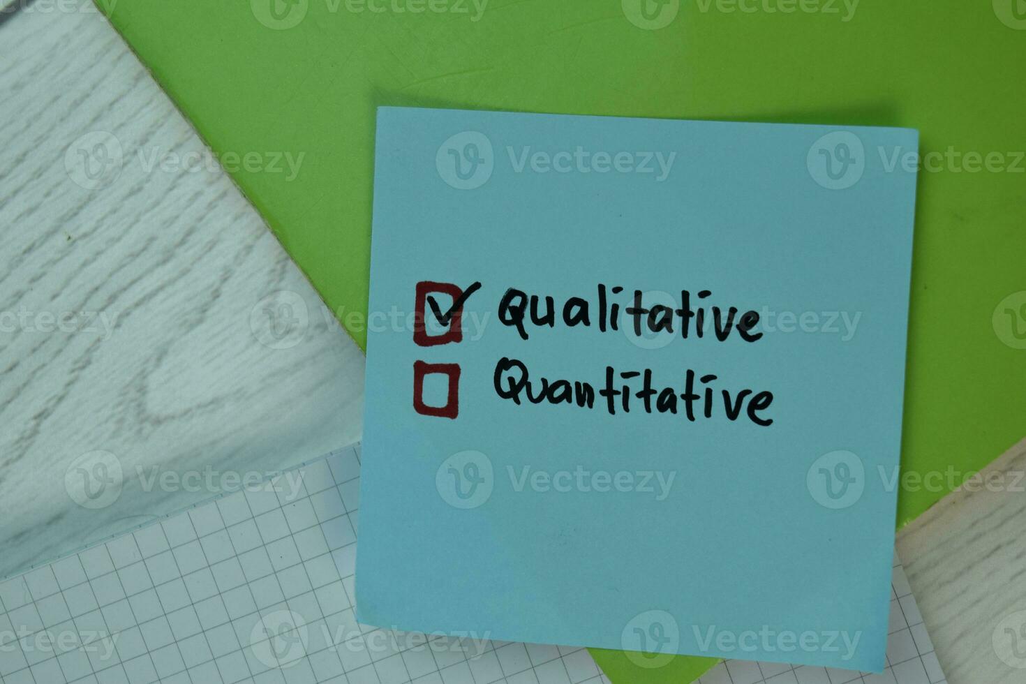 Qualitative and Quantitative write on sticky notes and supported by additional services isolated on Wooden Table. photo