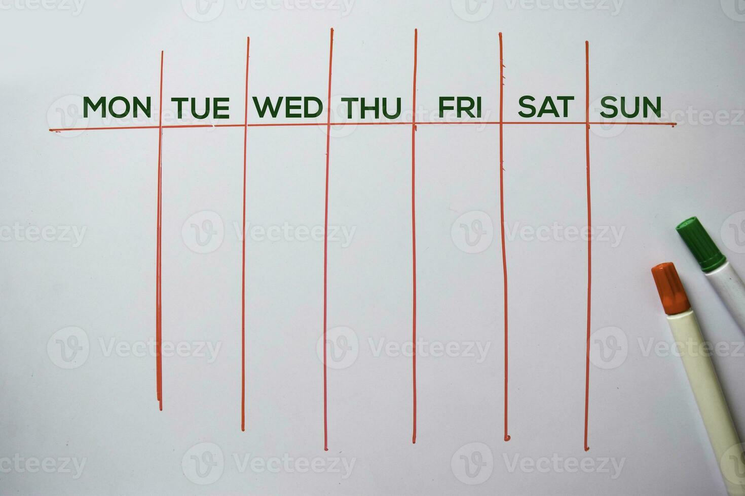 Weekly Calendar text isolated on white board background. photo