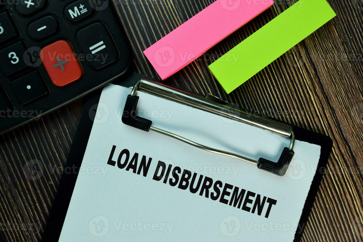 Loan Disbursement write on a paperwork isolated on Wooden Table. Finance concepts photo