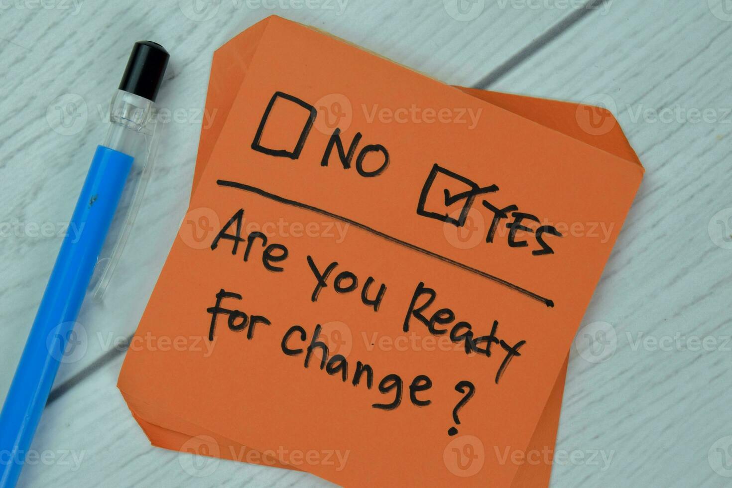 Concept of Are you Ready for Change Yes write on sticky notes isolated on Wooden Table. photo