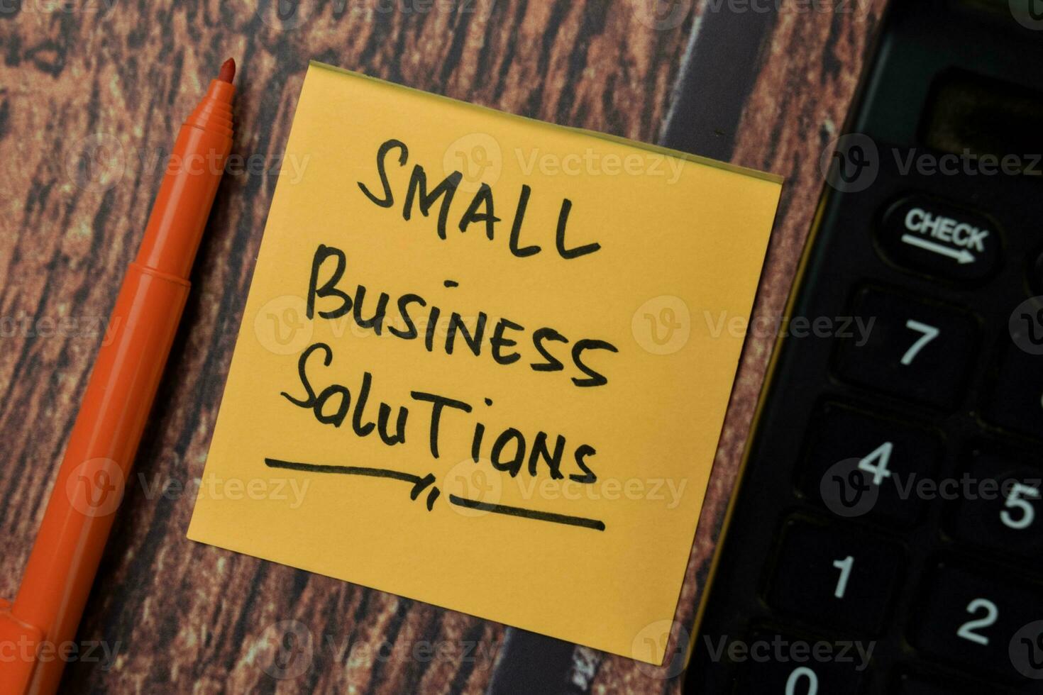 Small Business Solutions write on sticky notes isolated on office desk. photo
