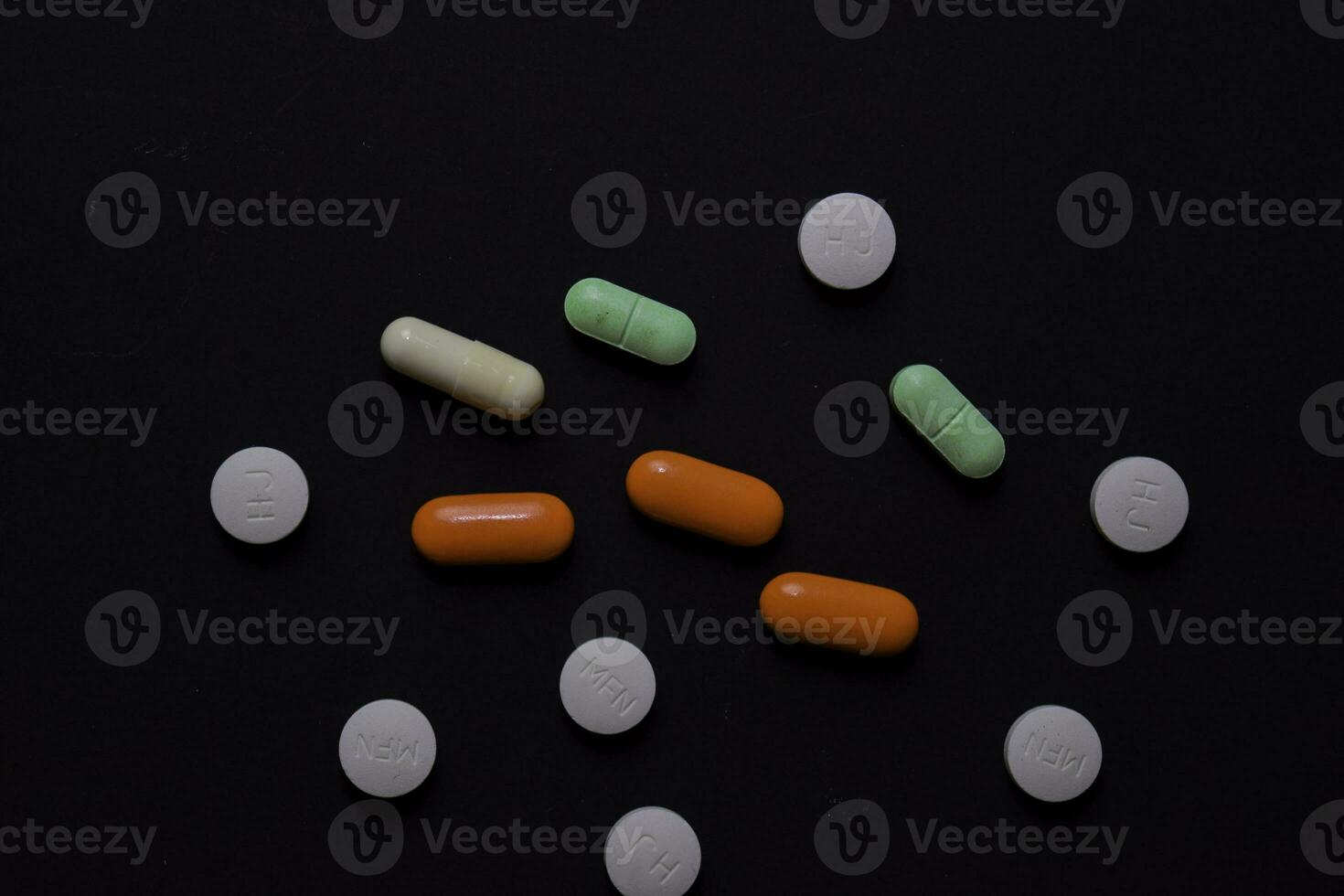 colorful medication and medicine pills, tablets and capsules. Isolated on office desk background. Medical or Healthcare concept photo