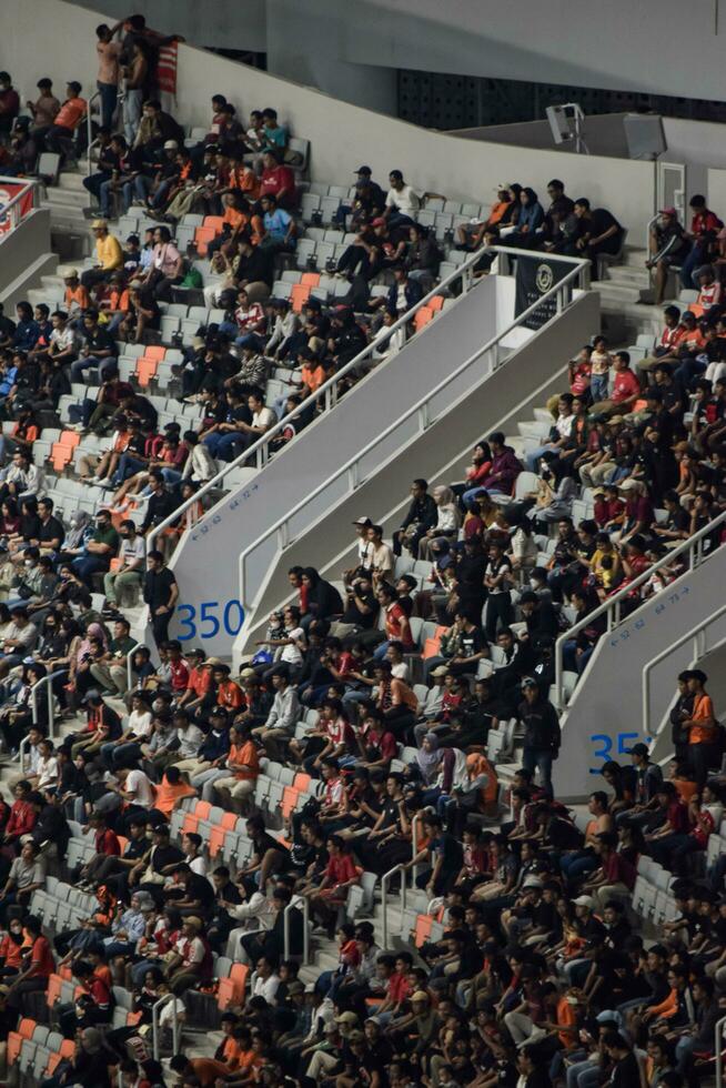 Crowds on Group of fans on the stadium Jakarta International Stadium. Jakarta, Indonesia, August 1, 2022 photo