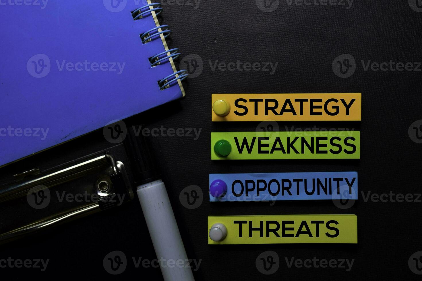 Strategy, Weakness, Opporunity, Threats text on sticky notes isolated on Black desk. Mechanism Strategy Concept photo
