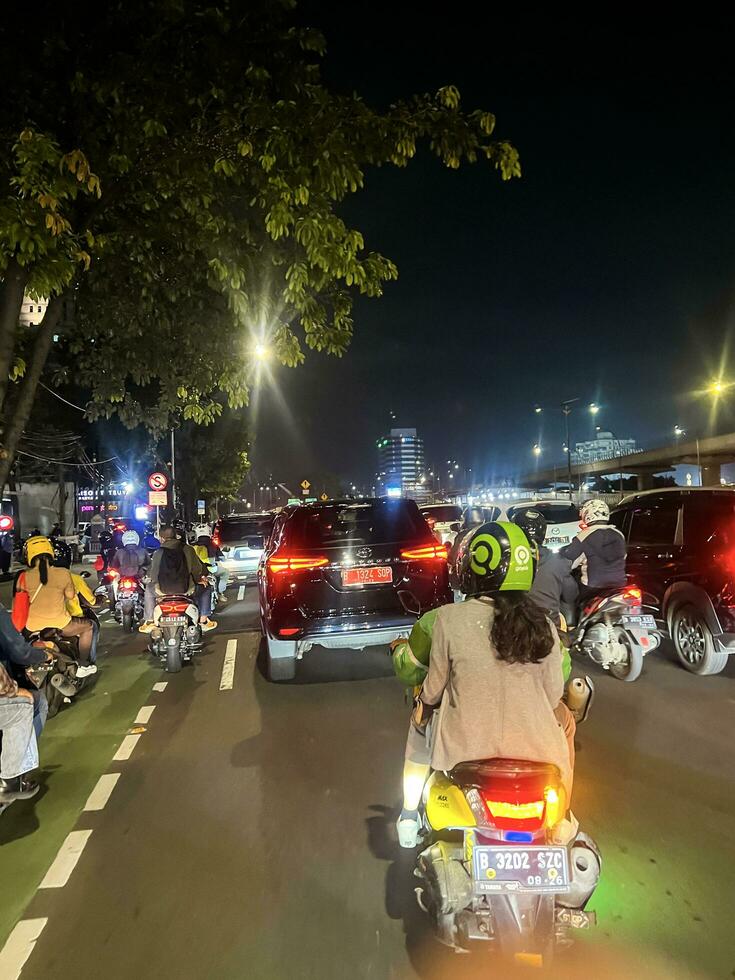 Night view busy in Jakarta Motorway traffic jam at night. Jakarta, Indonesia, December 24, 2022 photo